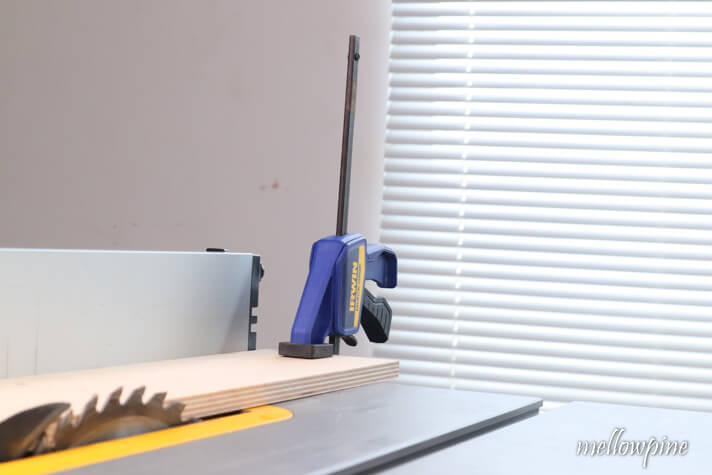 plywood piece clamped to the table saw