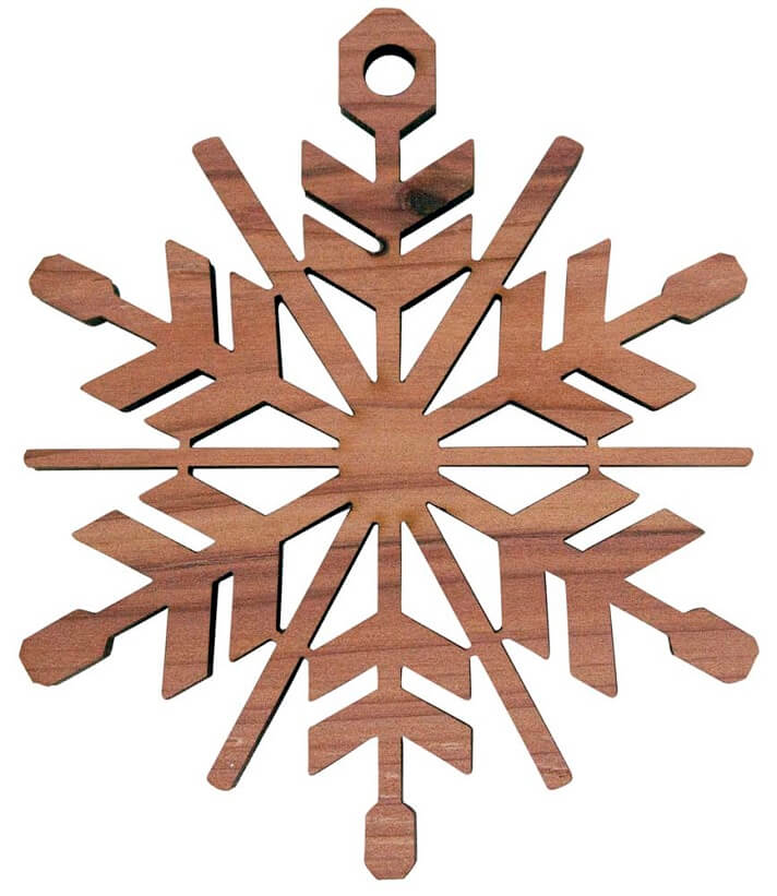 A snowflake design laser cut from cedar wood