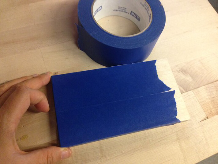 Applying masking tape on the surface of the workpiece (Source Exploratorium)