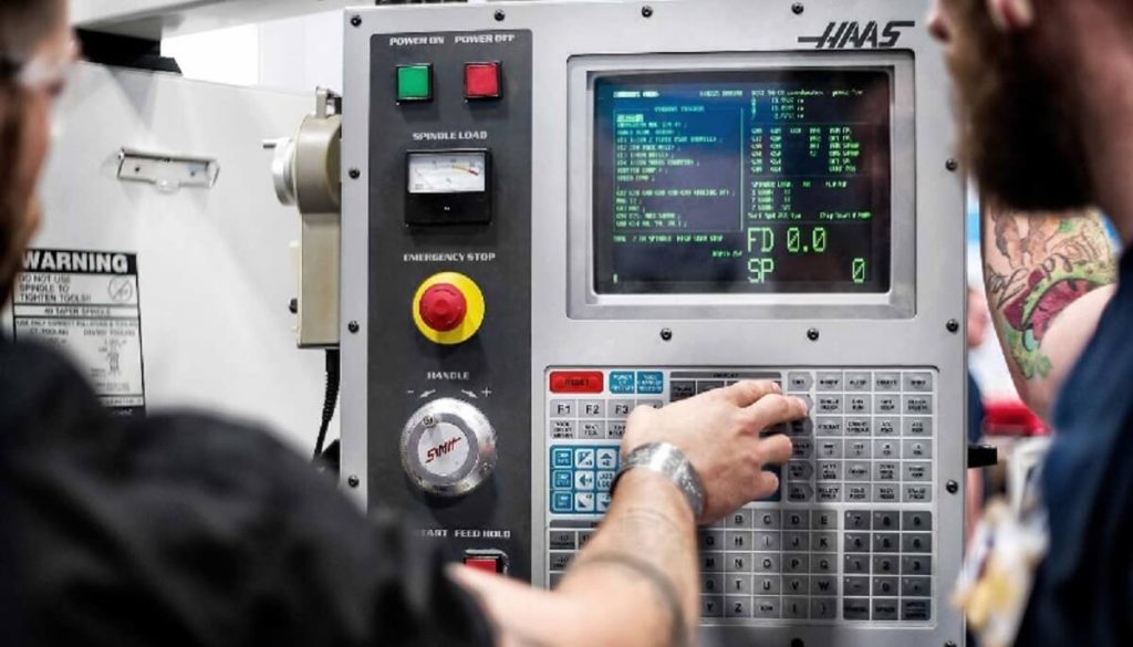 CNC operator operating a CNC machine