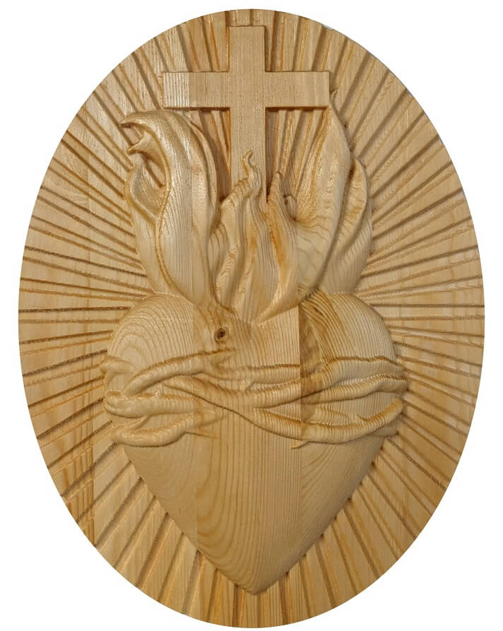 Sacred heart image carved on pine wood