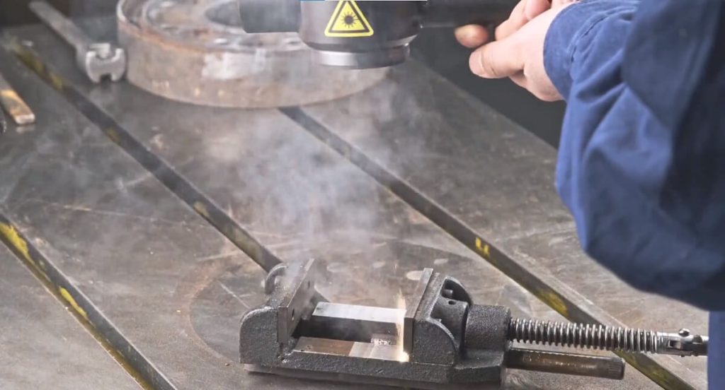 Using a hand-held fiber laser to remove rust