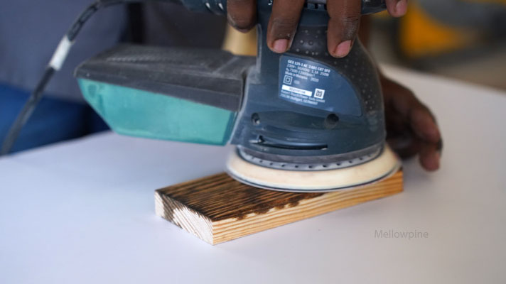 sanding a danish oil coated pine wood surface