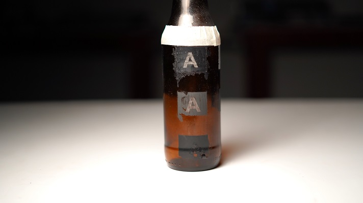 Test engravings performed on a wine bottle