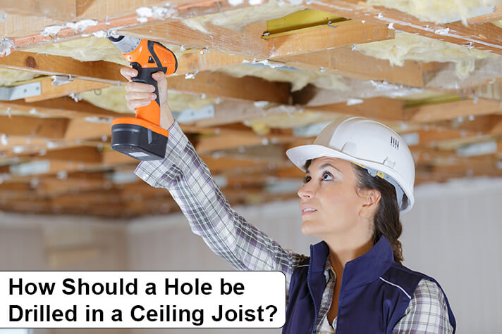 How Should a Hole be Drilled in a Ceiling Joist?