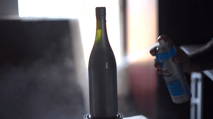 Spray painting on a wine bottle