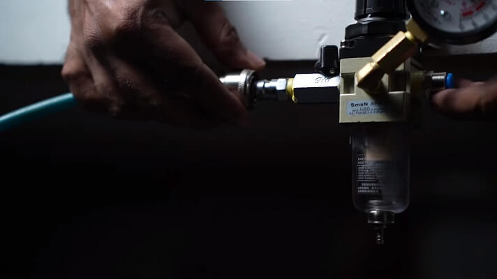Using the quick connect coupling to connect the air compressor output to the regulator