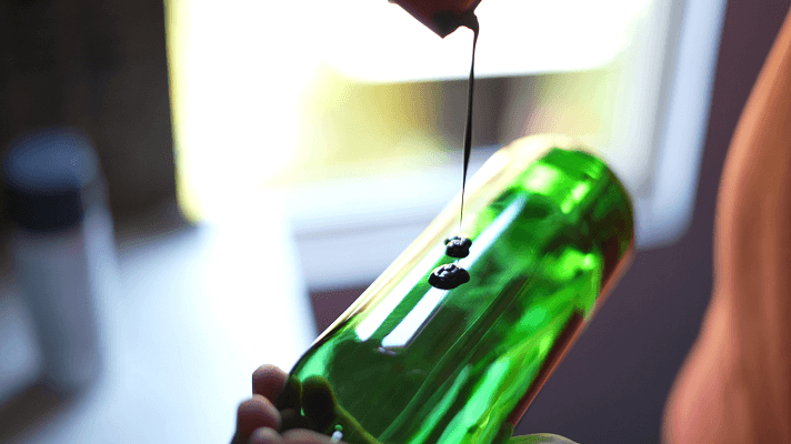 Applying paint on a wine bottle