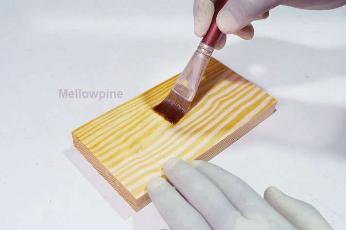 Applying Tung oil using brush