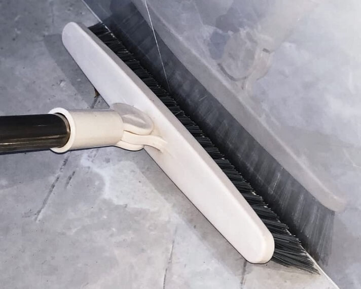 Cleaning the tile floor to remove any dust or debris