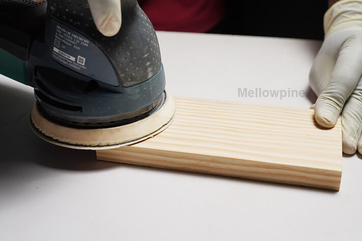 Sanding the workpiece to achieve a smooth finish