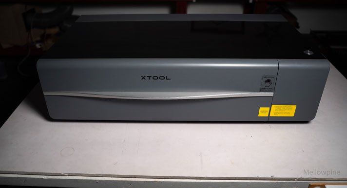 xTool P2 sitting on a workbench