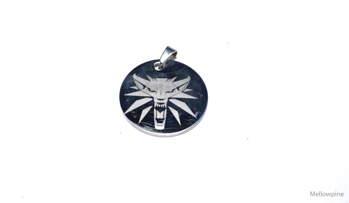 A design engraved on a steel pendant using xTool S1's IR module