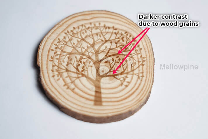 Laser engraving with uneven contrast due to wood grains