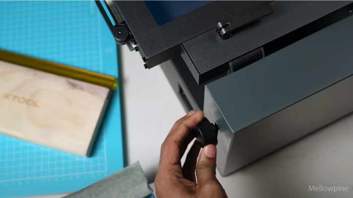 Pressing down the screen and tightening the screw