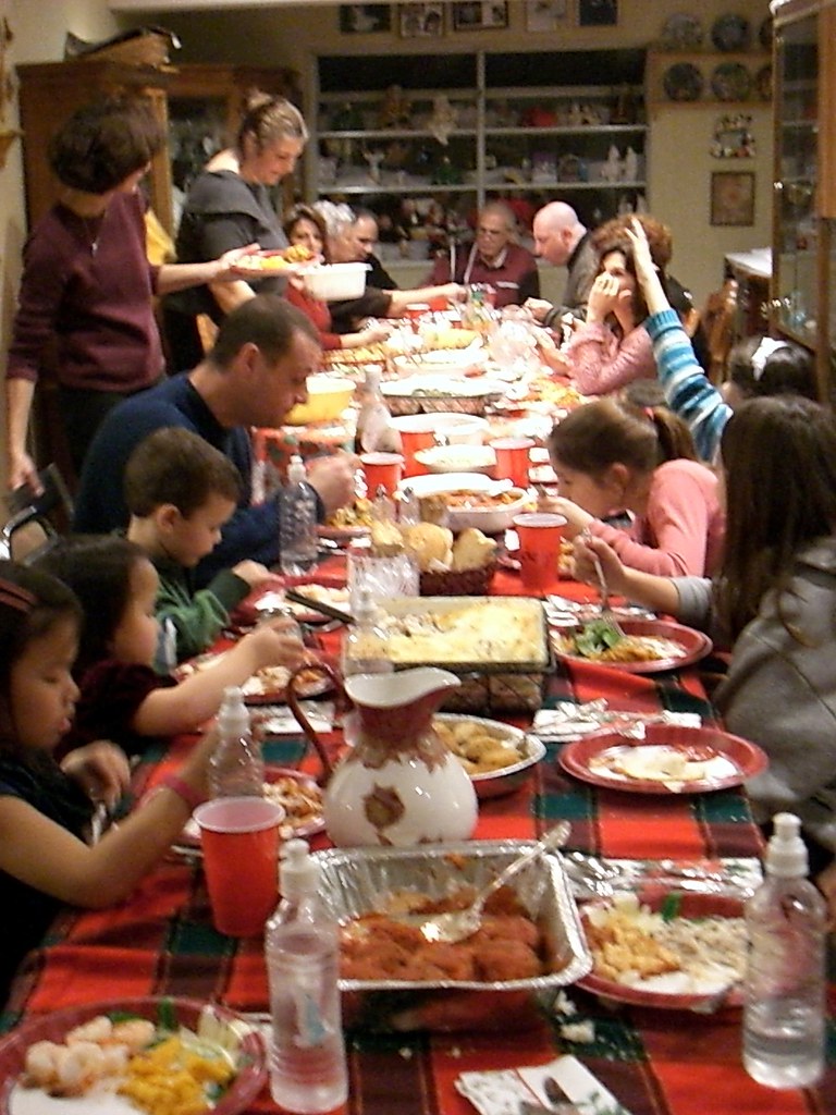 Family gathering around dinner table
