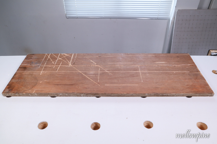 placing sacrificial board over work table